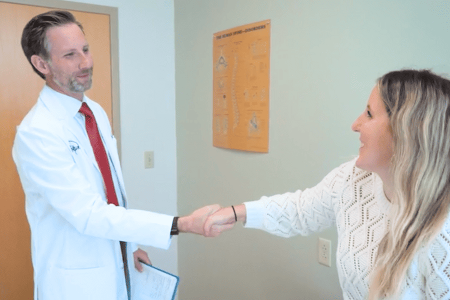 Ryan F. Moncman, D.O. greeting patient with handshake