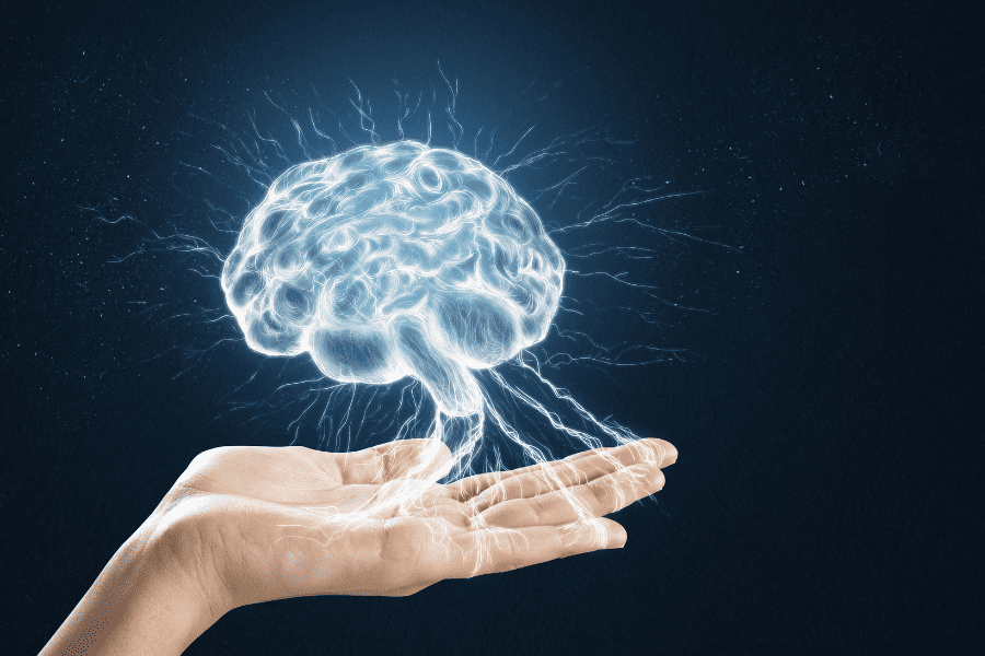 hand with illustration of brain with ellectrical lights indicating brain activity
