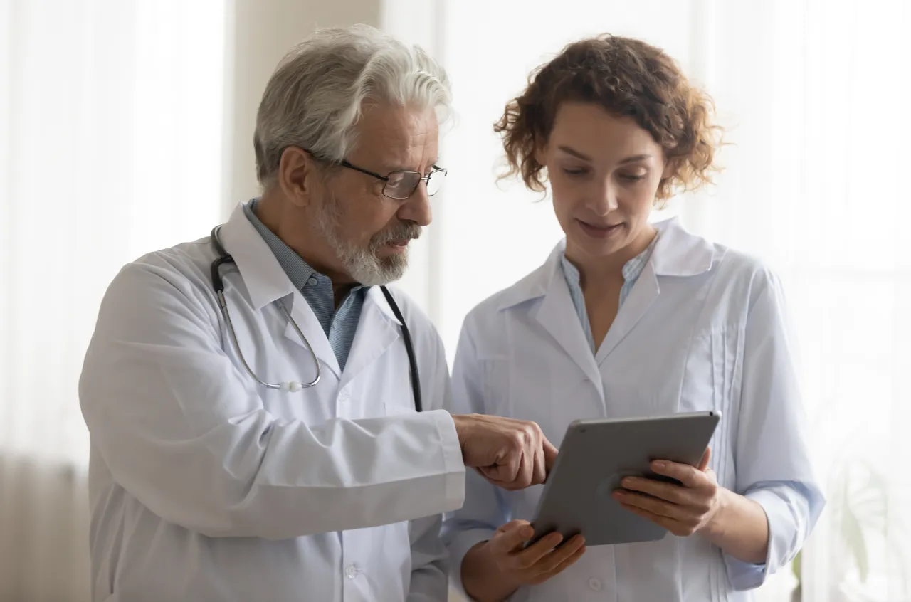 Woman and doctor discussing on tablet